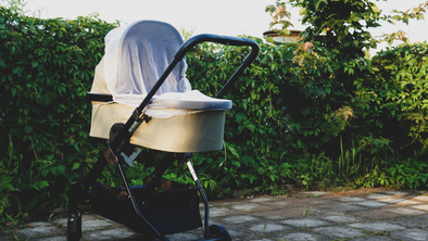 Canva Image showing a pram covered in a light cloth
